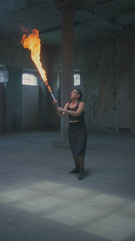 Woman doing a dance with a stick in fire