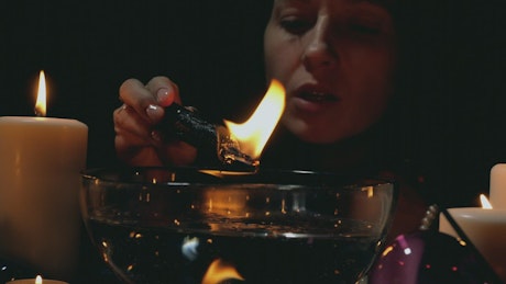 Woman doing a ritual with a candle