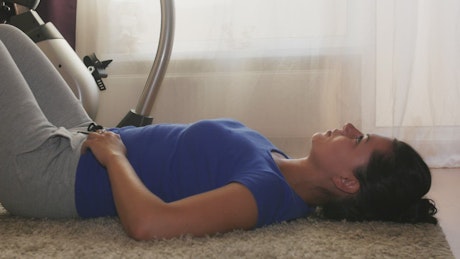 Woman doing breathing exercises in her home.