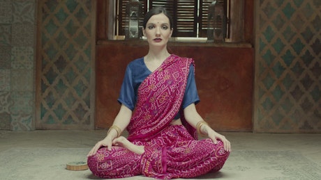 Woman doing yoga in a Hindu dress.
