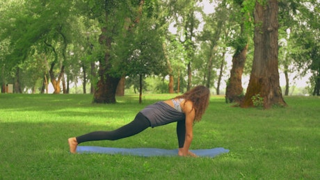 Woman doing yoga in a park