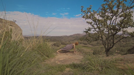 Woman doing yoga in nature.