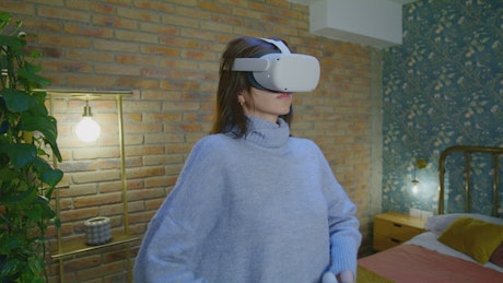 Woman doing yoga with virtual reality glasses.