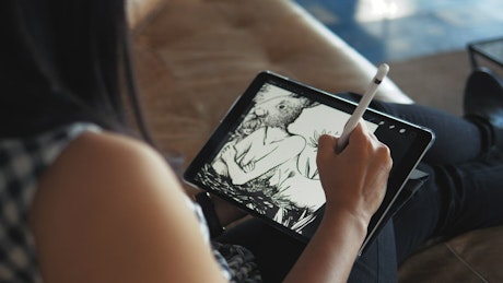 Woman drawing on a tablet