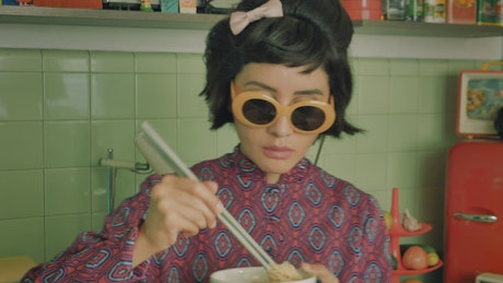 Woman eating noodles.