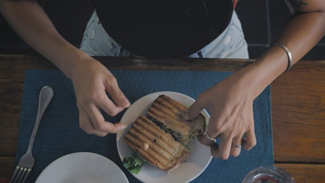 Woman eating salad and sandwich