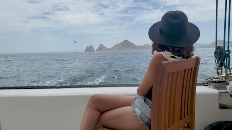Woman enjoying the sea in a boat.