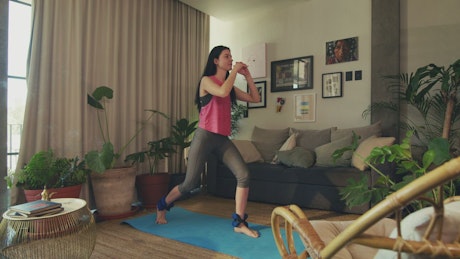 Woman exercising in her living room.
