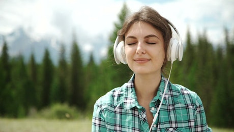Woman feels happiness when listening to music