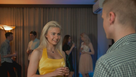 Woman flirting with a man at a party.
