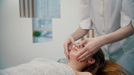 Woman getting a face massage in a spa