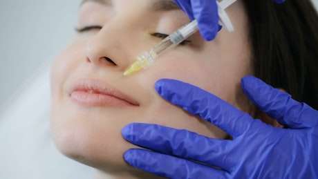 Woman getting botox on her lips, close up.