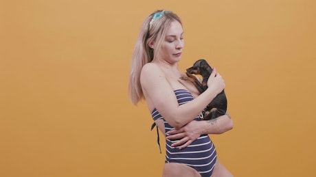Woman holding a Chihuahua.