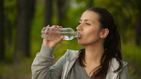 Woman hydrating after exercising.