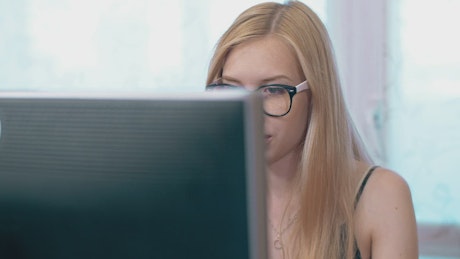 Woman in eyeglasses working in office