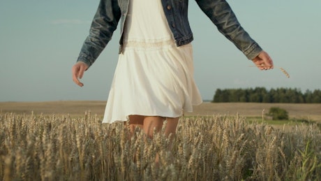 Woman in white dress dancing in the field.