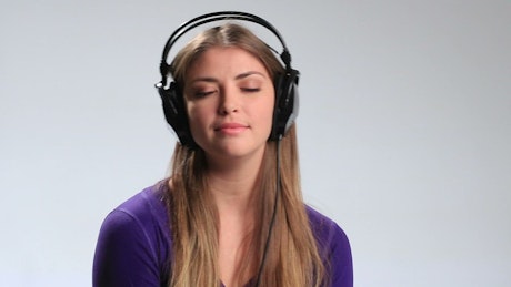 Woman listening to music on her headphones.