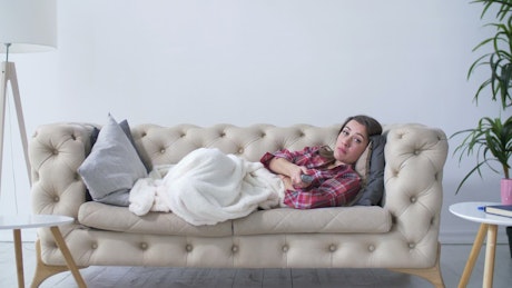Woman lying on a sofa.