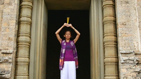 Woman outside of a buddhist temple.
