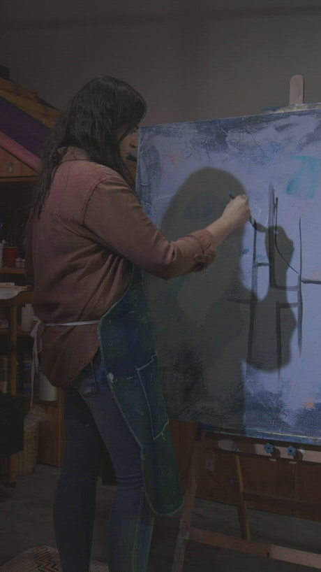 Woman painting in her studio.
