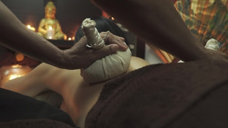 Woman performing Thai Buddhist massage.