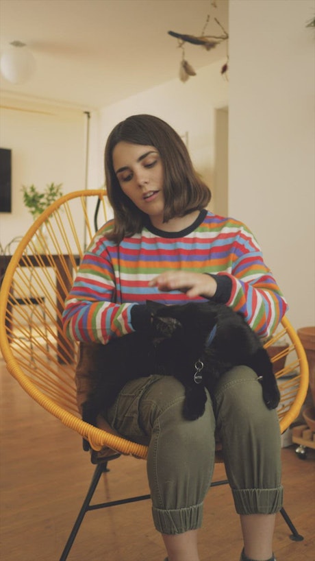 Woman petting a cat.