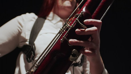 Woman playing a jazz tune on the bassoon.
