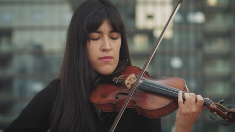 Woman playing the violin with skill