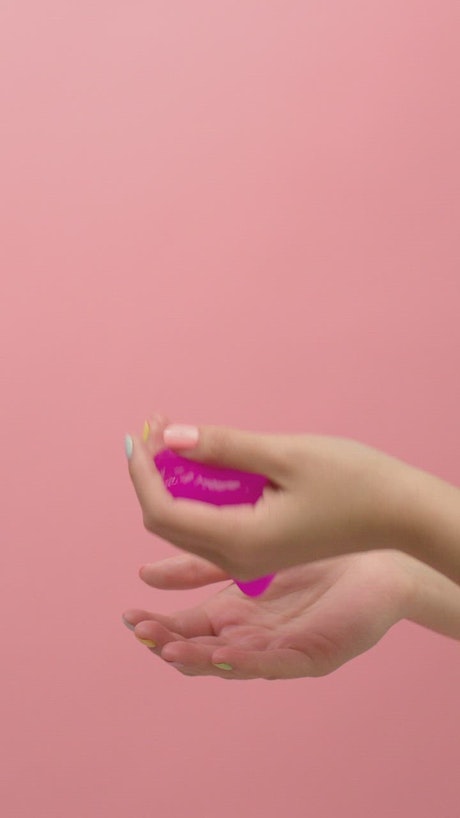 Woman playing with slippery pink Slime.