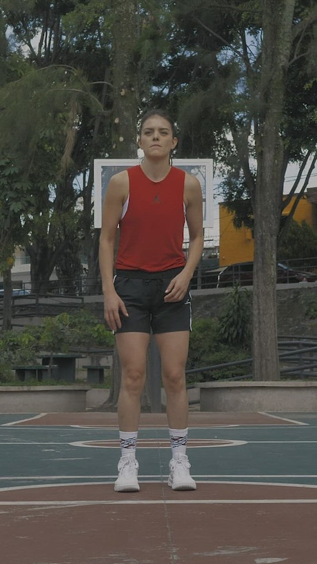 Woman practicing free throws.