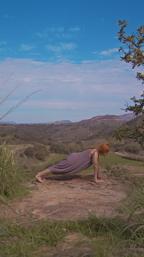 Woman practicing yoga in the middle of nature.
