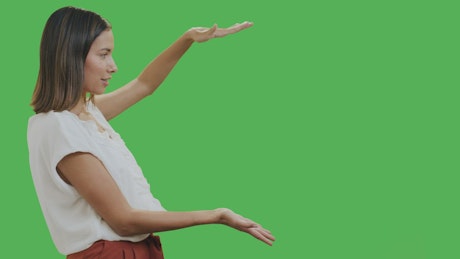 Woman presenting something with chroma background.