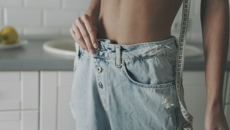 Woman pulls out jeans to show off weight loss