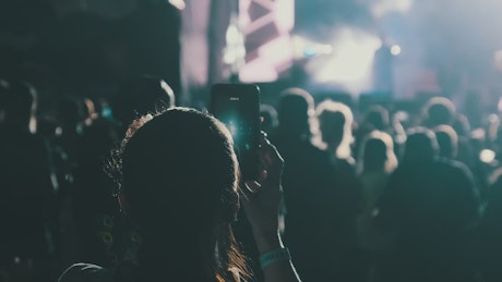 Woman recording a story from a concert