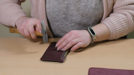 Woman repairing a wallet