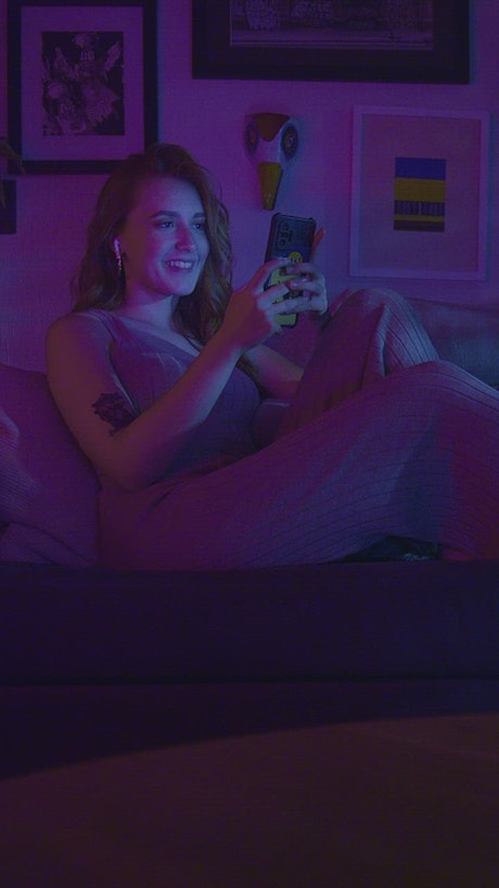 Woman resting and taking selfies at night.