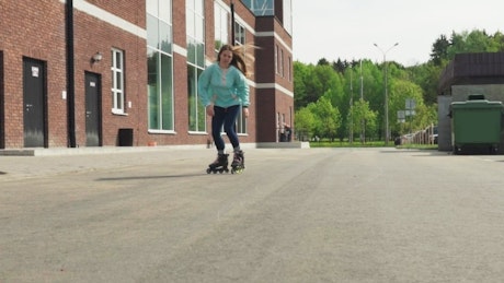 Woman rollerblading gracefully along a road.