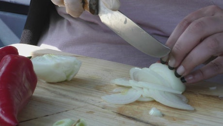 Woman slicing an onion on a board