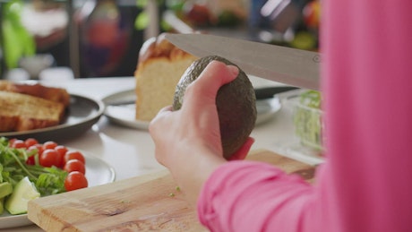 Woman slicing and chopping an avocado.