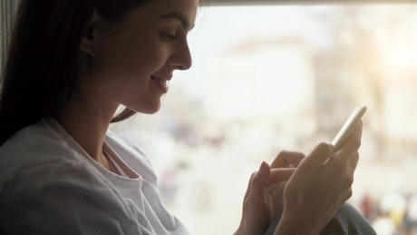 Woman smiles while using mobile app
