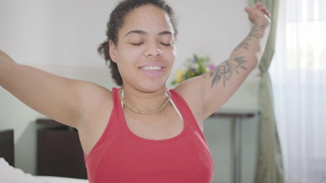Woman stretching her body after waking up