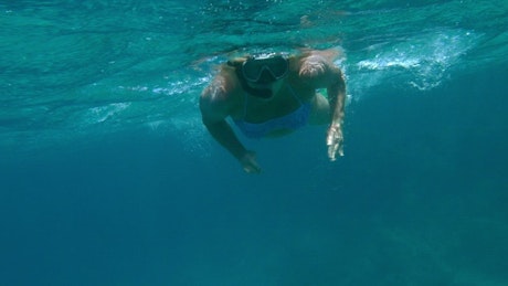 Woman swimming with a snorkel