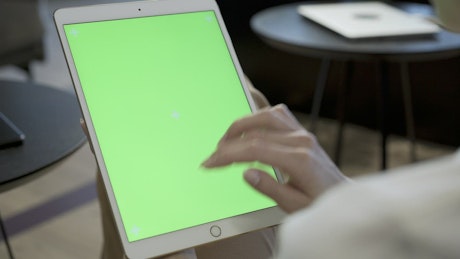 Woman swiping fingers on a tablet