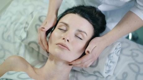 Woman taking rejuvenation therapy on face.