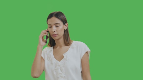 Woman talking on the phone with chroma background.