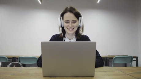Woman talking online with headphones