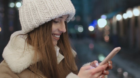 Woman texting happily on social media