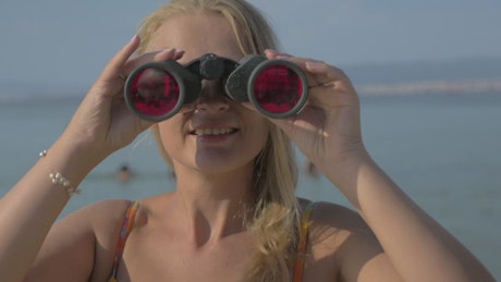 Woman using binoculars.