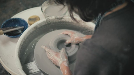 Woman using pottery wheel