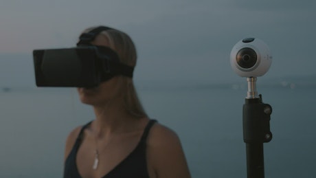 Woman using VR and a camera.